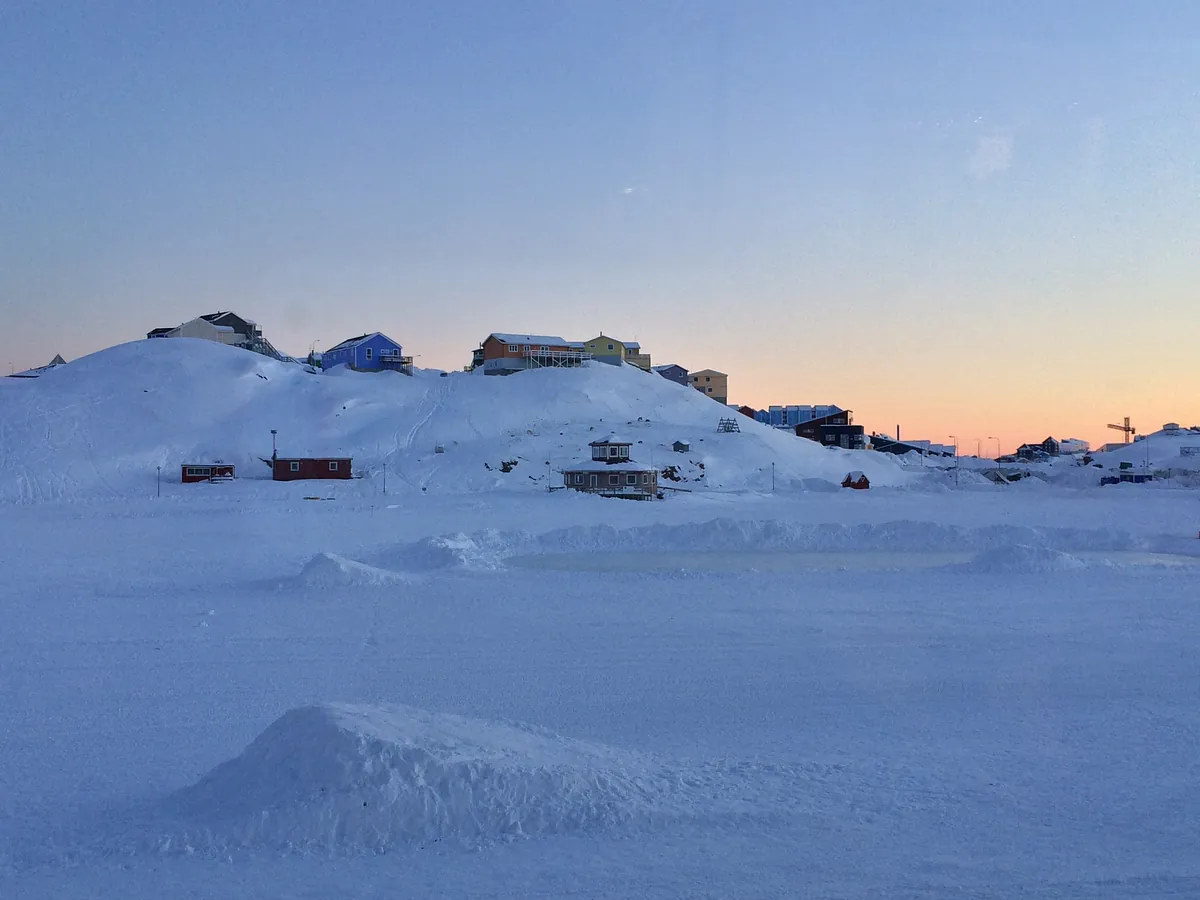 Greenland Artic Landscape with Houses strewn about along a hillside.