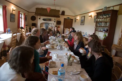 A group of Songwriters in Ireland gathered around a table.